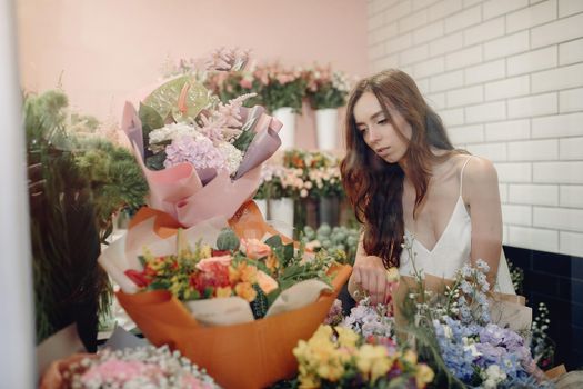 Girl with a flowers. Florist making a bouquet