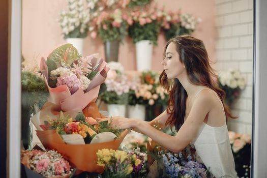 Girl with a flowers. Florist making a bouquet