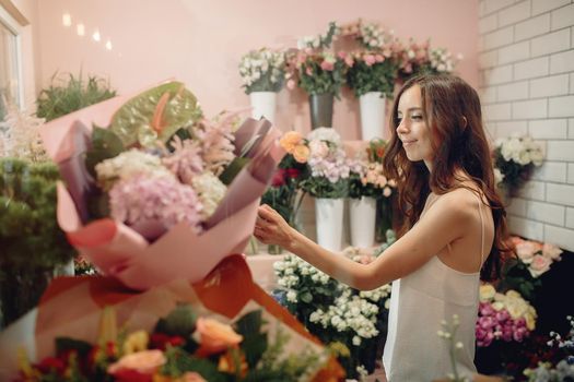 Girl with a flowers. Florist making a bouquet