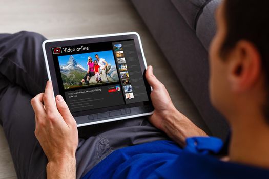 Man watching videos online on tablet.