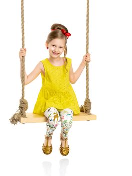 Happy little girl gaily swinging on a swing. The concept of a summer vacation in nature, a family vacation with the family on the beach or the sea. Isolated on white background.