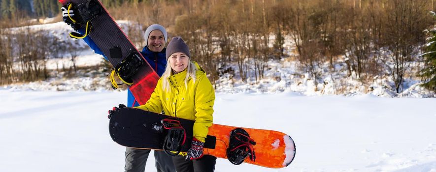 family with snowboards at winter resort