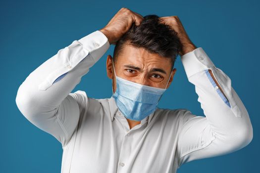 Handsome mixed-race man wearing medical face mask close up