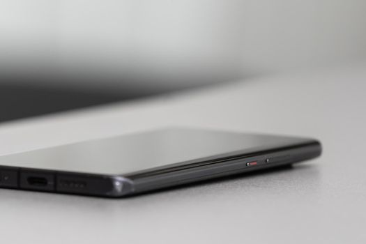 A single mobile phone on gray table