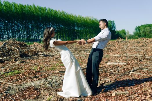 Just married couple together in poplar background