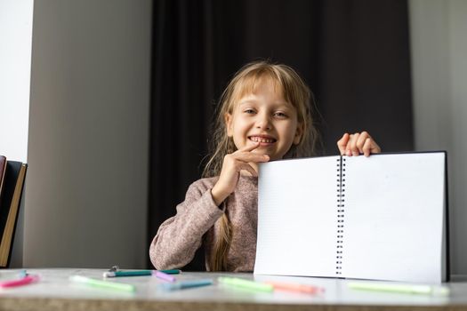 Little girl is doing his homework for elementary school.