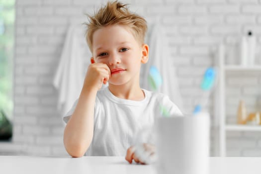 Little boy portrait standing in a light bathroom