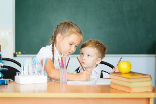 Cute girl and her little brother learning together.