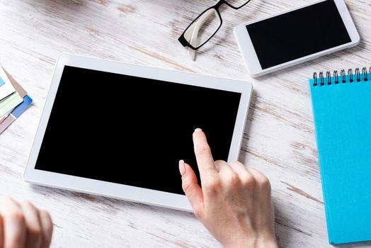 Business lady sitting at desk with tablet computer. Mobile smart devices in business processes. Business occupation and innovation. Corporate office workplace with business woman at wooden desk.