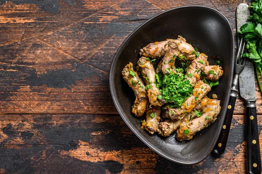 Stew with Chicken Neck meat and vegetables. Dark wooden background. Top view. Copy space.