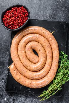 Raw spiral spicy sausage from pork and beef mince meat. Back background. Top view.