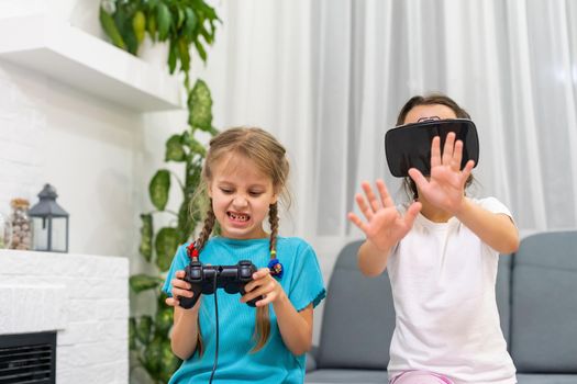 two little girls playing video games virtual reality glasses