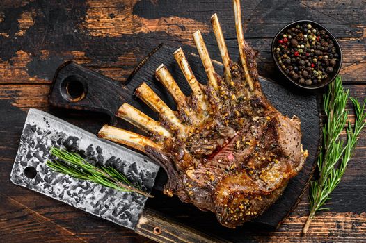 Grilled rack ribs of lamb meat chops. Dark wooden background. Top view.