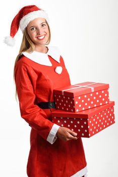 Blonde woman in Santa Claus clothes smiling with gift boxes in her hands. Young female with blue eyes, isolated on white
