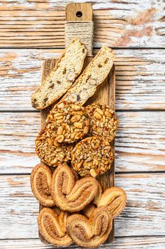 Mix of sweet cookies with glass of milk. white wooden background. Top view