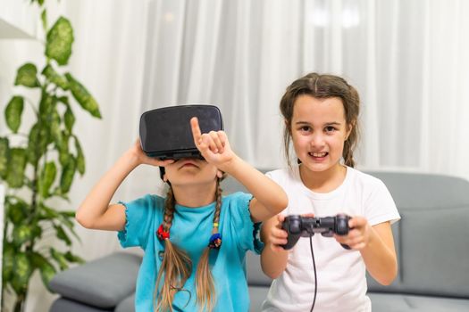 two little girls playing video games virtual reality glasses