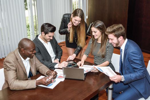 Businesspeople, teamwork. Group of multiethnic busy people working in an office