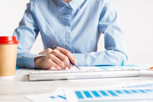 Business consultant sitting at desk and analyze financial report. Strategy planning and investment. Corporate office workplace with analyst at wooden desk. Business accounting and management.