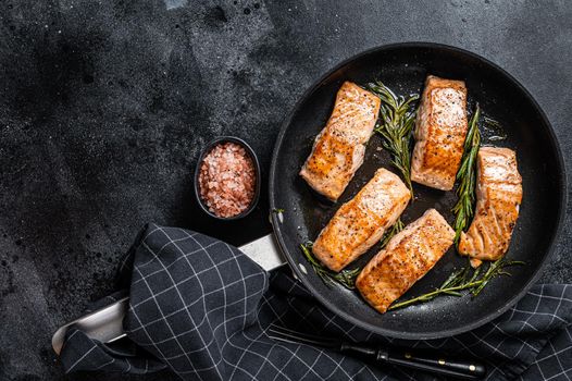 Grilled Salmon Fillet Steak in a pan. Black background. Top view. Copy space.