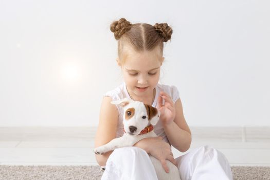 Pets and animal concept - Child girl hold puppy.