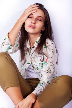 young pretty teenage hipster girl posing emotional happy smiling on white background, lifestyle people concept close up