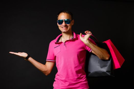 young caucasian man is holding shopping bags