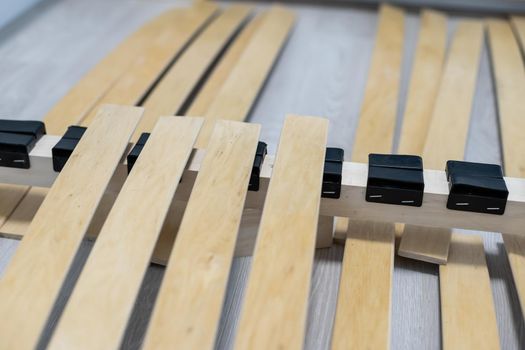 Broken wooden plank or lamella in bed. Need for furniture repair.