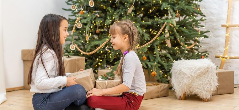 Two little girls with a christmas present