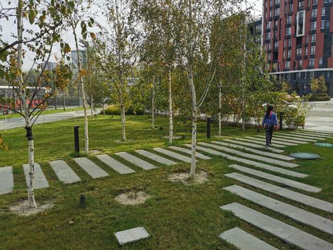 A sign over a grassy area with trees in the background. High quality photo