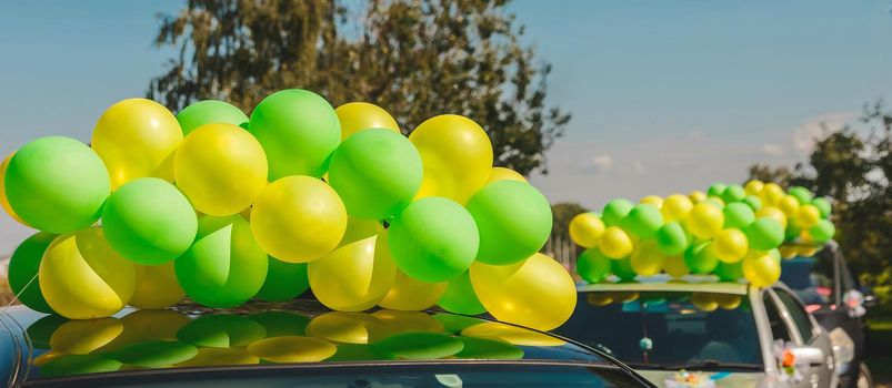 Colorful bright balloons against the blue sky close-up.