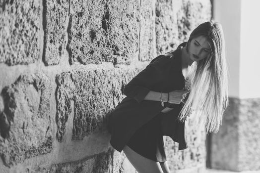 Portrait of young blonde girl wearing casual clothes in urban background