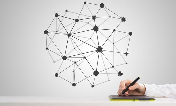 Hand of man drawing connection lines with stylus on tablet