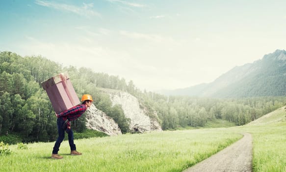 Man carrying on his back large box