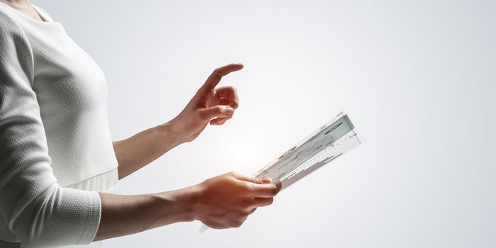 Woman hand touching virtual screen with pen. Online project management and financial diagrams visualization. Modern business innovation and intelligence technology. Data analysis futuristic concept