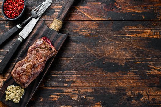 Grilled rump marble black angus beef steak. Wooden background. Top view. Copy space.