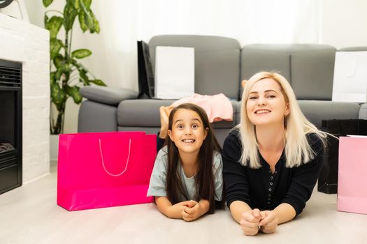 holidays, presents, christmas, x-mas, birthday concept - happy mother and child girl with gift bags