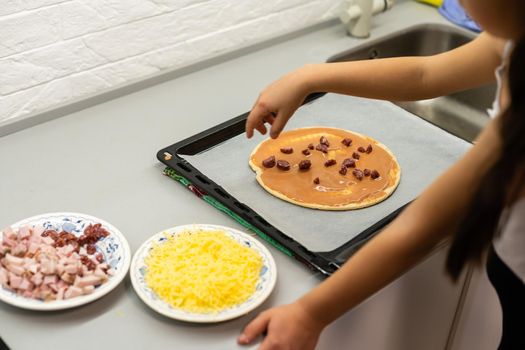 child cook homemade pizza, little girl makes pizza at home