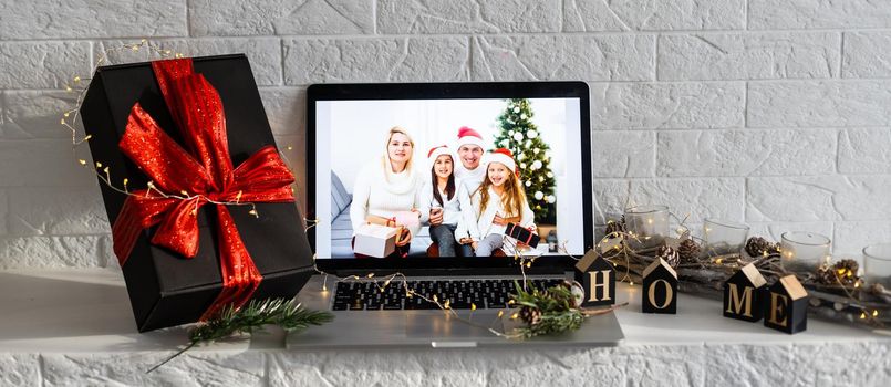 Laptop on the christmas table. Video call with the family in times of coronavirus