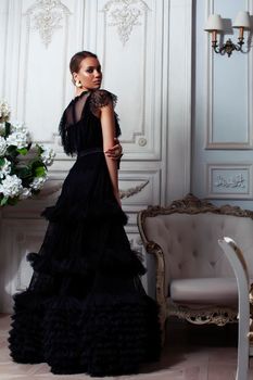 young pretty lady in black lace fashion style dress posing in rich interior of royal hotel room, luxury lifestyle people concept closeup