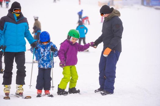 Tourists enjoy to play ski and snowboard at ski resort on holiday.