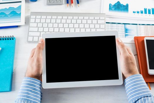 close-up of men's hands with a computer tablet. Businessman works in the office