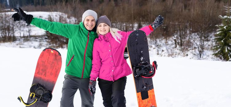 family with snowboards at winter resort