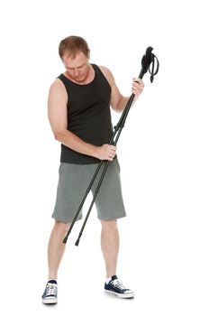 The concept of sports lifestyle and maintenance of health in adulthood. Fifty-year-old man, engaged in Nordic walking with special poles. Isolated on white background