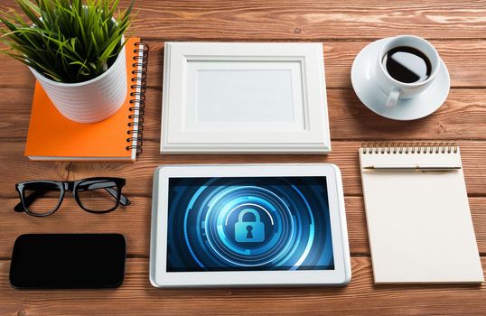 Business workplace with office stuff and tablet with padlock icons on screen