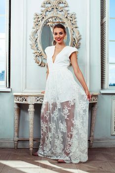 young pretty lady in white lace fashion style dress posing in rich interior of royal hotel room, luxury lifestyle people concept, bride on wedding day closeup