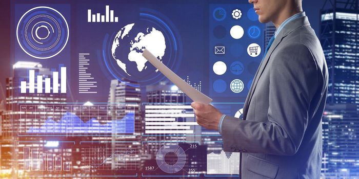 Rear view of businessman against virtual panel interface holding papers in hand