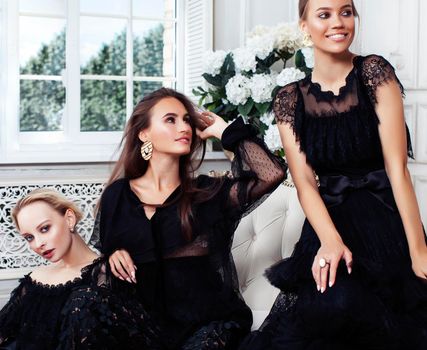 three young pretty lady in black lace fashion style dress posing in rich interior of royal hotel room, luxury lifestyle people concept closeup