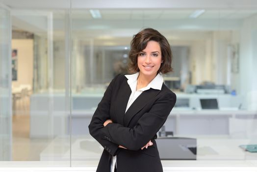 Portrait of a business woman in a office. Crossed arms