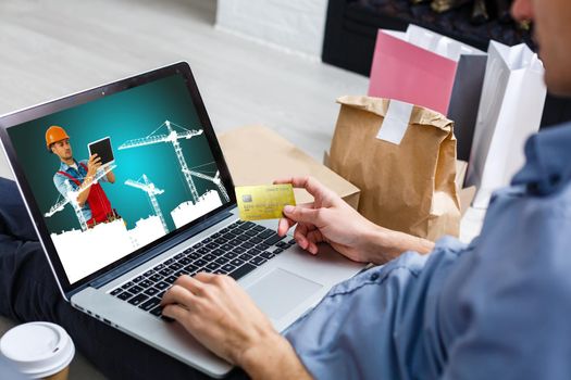 young manual worker displaying laptop over white background
