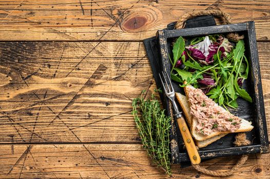 Tuna Salad Sandwich with Cheese, lettuce and arugula. Wooden background. Top view. Copy space.